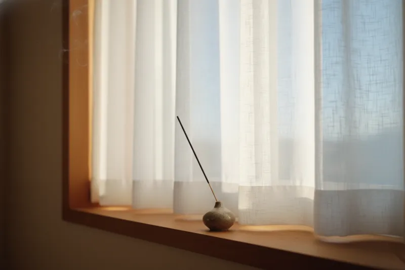 창가에서 피어오르는 일본식 인센스 스틱 장면